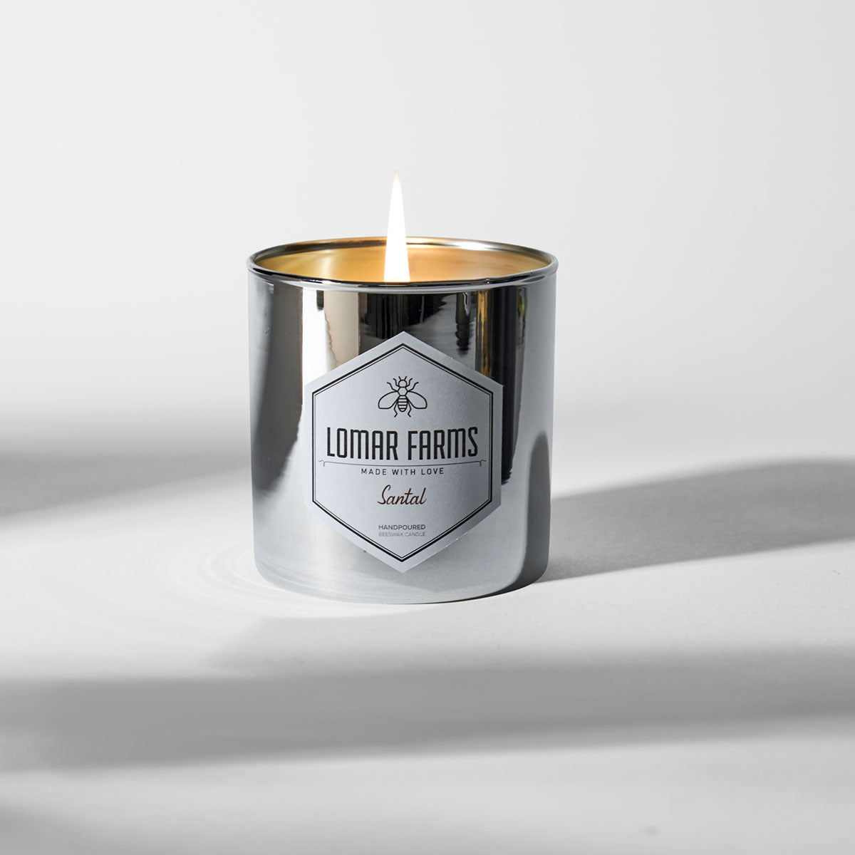 Santal Beeswax Candle 11 oz mirrored silver jar